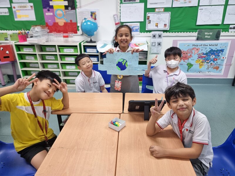 A Secondary student reading a book for the Early Years student